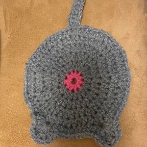 This is a grey crochet cat butt coaster made by me